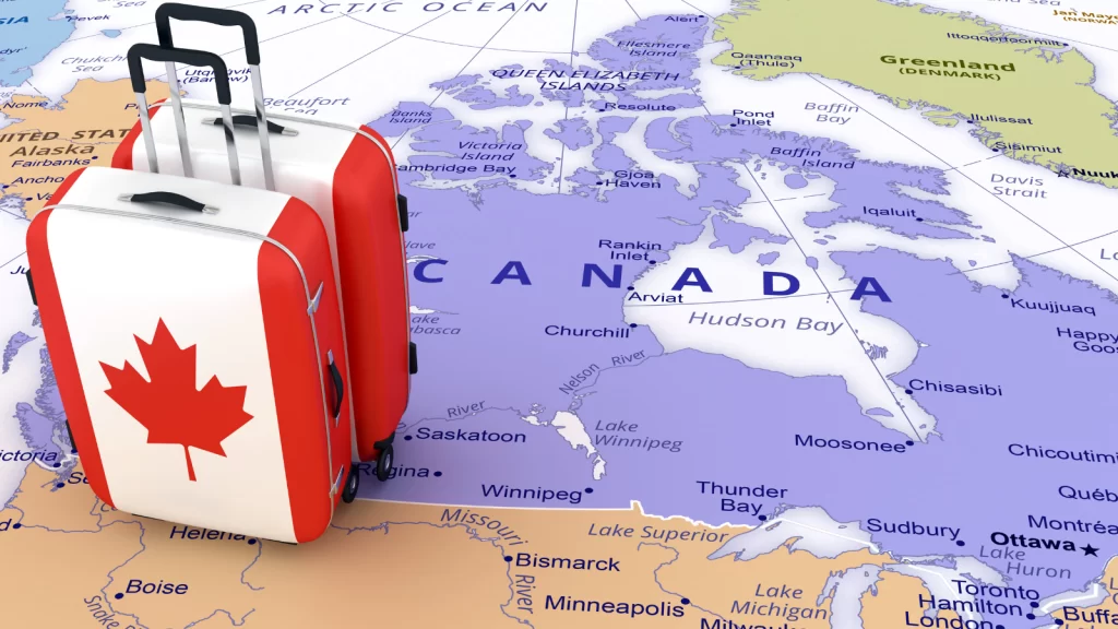 خريطة كندا وحقيبتين سفر عليها علم كندا - الوظائف والمهن المطلوبة في كيبيك