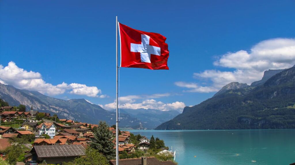 احدى مدن سويسرا مع علم سويسرا - الضمان الاجتماعي في سويسرا